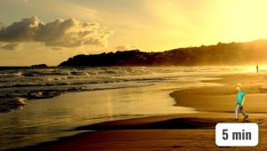 a man running on the beach at sunset at Appartamento Deluxe Centrale, in Gaeta