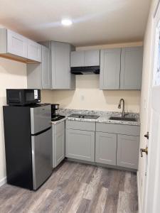 a kitchen with white cabinets and a black refrigerator at Toiyabe Motel in Walker