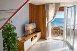 a living room with a television and a view of the ocean at Luxury sea view duplex in Durrës
