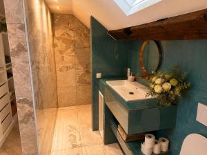 a bathroom with a sink and a shower at Penthouse city & cathedral View for 4 in Antwerp +4 photos