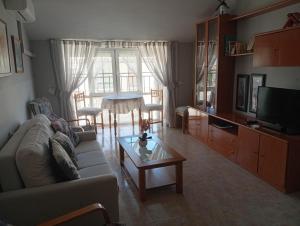 a living room with a couch and a table at Apartamento manchego Macrina in Villarta de San Juan