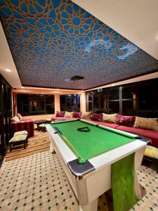 a billiard room with a pool table in it at Riad Tama & SPA - Authentic Ourzazate Stay in Ouarzazate