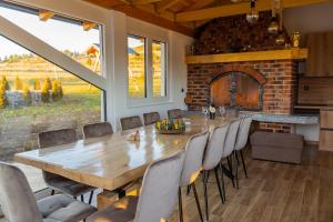 a large dining room with a large wooden table and chairs at Villa Antonela Kupres in Kupres