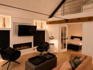 a living room with a couch and a fireplace at Penthouse city & cathedral View for 4 in Antwerp