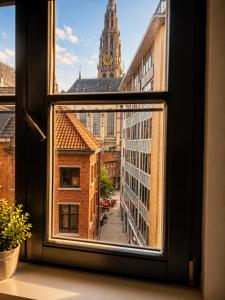 a view of a city from a window at Penthouse city & cathedral View for 4 in Antwerp