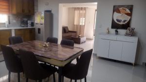 a kitchen with a dining room table and chairs at Johanna 1 in Los Tres Ojos de Agua