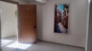 a door in a room with a picture on the wall at Johanna 1 in Los Tres Ojos de Agua +2 photos