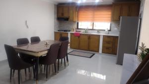 a kitchen with a table and chairs in a room at Johanna 1 in Los Tres Ojos de Agua