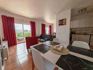 a kitchen and living room with a table and chairs at Vila Apostol in Lagos