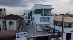 a large white building on top of a city at Studio Apartment -LIAM Signature Akowonjo Egbeda in Akinde