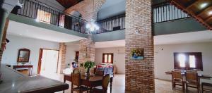 a living room with a table and a brick wall at Hospedaria 33 in Barretos +52 photos
