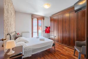 a bedroom with a bed and a desk and a chair at Maranello Suite in Maranello +24 photos