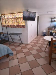 a living room with a flat screen tv on the wall at Rincon Hortensia apartments and loft in Oaxaca City +45 photos