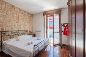 a bedroom with a bed and a glass door at Maranello Suite in Maranello