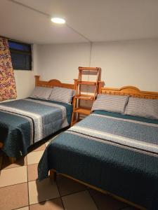 a room with two beds and a ladder at Rincon Hortensia apartments and loft in Oaxaca City