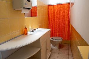 a bathroom with a sink and a toilet at Hotel Posada La Ermita Cobán in Cobán +21 photos