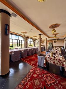 a restaurant with tables and chairs in a room at Riad Tama & SPA - Authentic Ourzazate Stay in Ouarzazate