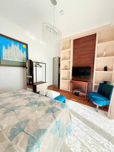 a bedroom with a bed and a chair and a television at Villa Chamare in Pero