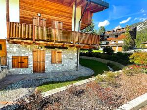 a house with a balcony on top of it at Alpine Heaven in Borca di Cadore
