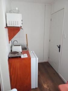 a room with a refrigerator and a microwave on a table at Borde Lago IV - V in Puerto Varas