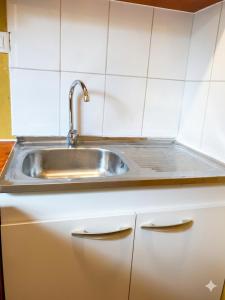 a kitchen with a sink and white cabinets at Borde Lago IV - V in Puerto Varas