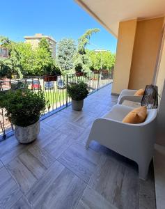 a balcony with two couches and plants on a building at Villa Chamare in Pero