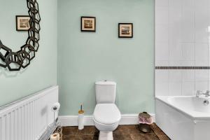 a bathroom with a white toilet and a sink at Spacious Stoke Townhouse 3BR Near Hospital & M6 with Parking in Stoke on Trent +19 photos