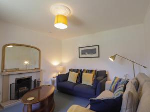 a living room with two couches and a mirror at Tigh a Phailean in Letterfearn