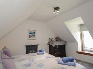 a bedroom with a bed with blue towels on it at Tigh a Phailean in Letterfearn