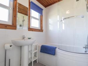 a bathroom with a sink and a toilet and a tub at Tigh a Phailean in Letterfearn +19 photos