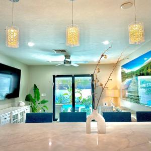a dining room with a table and chairs and a tv at Acqua Atelier by Vanderbilt Beach in Naples +33 photos