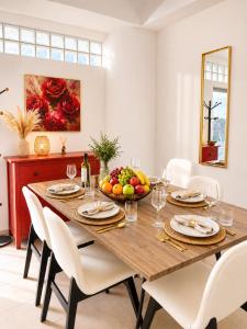 a dining room with a wooden table with a bowl of fruit at Best Seaview in Larnaca - 2 BDR Apt - 2 Min Walk to Beach in Larnaca +17 photos