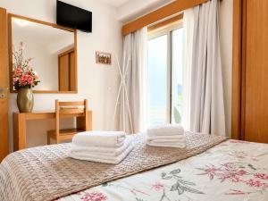 a bedroom with a bed with towels on it at Gerês Trail House in Geres +18 photos