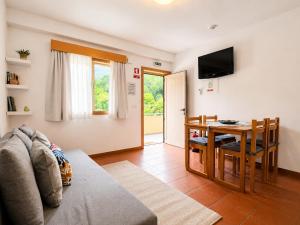 a living room with a couch and a table at Gerês Trail House in Geres