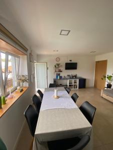 a dining room with a table and chairs in a room at Like a Local Guest House in Ericeira