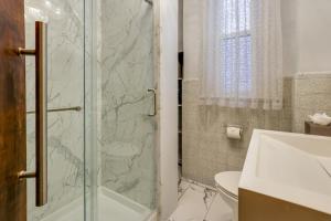 a bathroom with a shower and a toilet and a sink at Historic Georgetown Townhome: Walkable Location! in Washington, D.C. +28 photos
