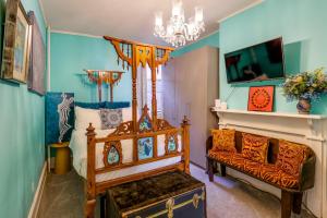 a room with a bed and a couch and a chandelier at Historic Georgetown Townhome: Walkable Location! in Washington, D.C.