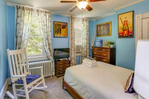 a bedroom with blue walls and a bed and a chair at Historic Georgetown Townhome: Walkable Location! in Washington, D.C.