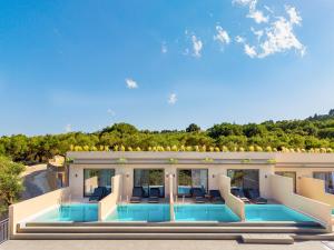a view of a house with a swimming pool at Helena's Aether Suites - Seaview & Heated Infinity Pool in Tragaki