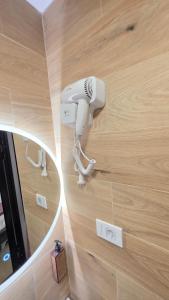 a hair dryer on a wall in a room at Kamel Rooms & Apartments in Bijelo Polje +50 photos