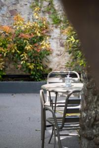 a table and chairs with a cup on top of it at Jo's Apartment in Mytilene