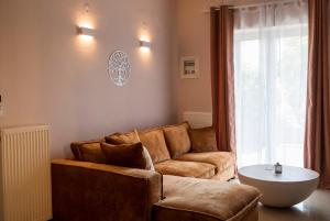a living room with a couch and a table at Jo's Apartment in Mytilene