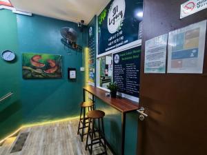 a bar in a restaurant with a counter and stools at Hotel SN Legacy in Kuala Terengganu
