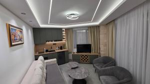 a living room with a couch and chairs and a table at Kamel Rooms & Apartments in Bijelo Polje