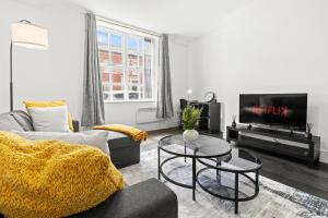 a living room with a couch and a tv at Cheshire Dimond one bedroom flat in Warrington in Warrington