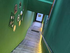 an overhead view of a hallway with a green wall at Hotel SN Legacy in Kuala Terengganu