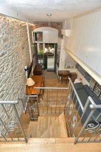 a room with a staircase and a stone wall at The Vernazza Main Plaza - Rooms & Suites in Vernazza