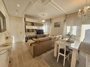 a living room with a couch and a dining room at A un paso de Bilbao in Galdakao