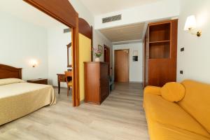 a hotel room with a bed and a couch at Hotel Persico's in San Giovanni in Persiceto +77 photos