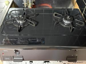 a stove top with two pots on top of it at Oyado Nishiki in Minamiizu +23 photos
